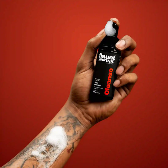 Hand holding a bottle of flauntyourink's foam cleanser