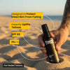 Person holding a sunscreen spray bottle on a beach with text highlighting its features.