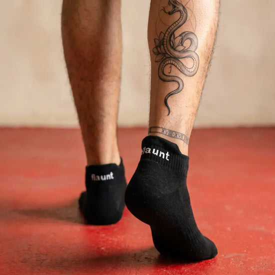 Flaunt Socks worn, walking away, red floor