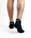 Flaunt Socks worn, walking away, white background
