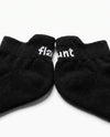 Flaunt Socks pair, flat lay, flaunt wordmark on cuff